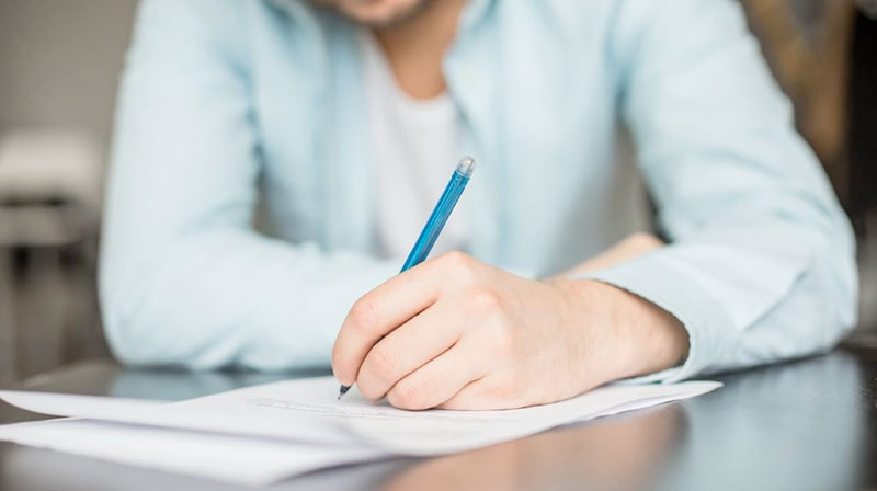 man writing a letter